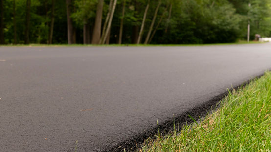 Side of the road showing asphalt and grass